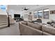 Spacious living area with modern sofa, staircase and abundant natural light at 8178 Eaton Hill St, Las Vegas, NV 89113