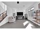Comfortable living room area with sleek entertainment center and modern staircase at 8178 Eaton Hill St, Las Vegas, NV 89113