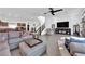 Open-concept living area featuring contemporary decor, staircase, and tile flooring at 8178 Eaton Hill St, Las Vegas, NV 89113