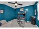 Home office with blue walls and ample storage solutions at 8178 Eaton Hill St, Las Vegas, NV 89113