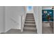 Bright staircase with white banister leading to the upper level, adjacent to a living space at 8178 Eaton Hill St, Las Vegas, NV 89113