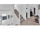 Bright, modern stairway with carpeted steps, white railings, and large windows, enhancing natural light at 8178 Eaton Hill St, Las Vegas, NV 89113