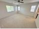 Spacious primary bedroom with ceiling fan and large windows at 8682 Gateway Glen Dr, Las Vegas, NV 89178