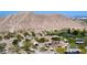 Scenic aerial view of a community park featuring play structures, lush greenery, and walkways against a mountainous backdrop at 8682 Gateway Glen Dr, Las Vegas, NV 89178