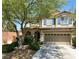 Charming two-story home featuring a well-maintained front yard and a spacious two-car garage at 8682 Gateway Glen Dr, Las Vegas, NV 89178
