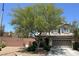 Inviting two-story home with a well-manicured front yard, mature tree, and a two-car garage at 8682 Gateway Glen Dr, Las Vegas, NV 89178