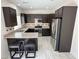 Well-equipped kitchen boasts stainless steel appliances, breakfast bar and ample cabinet space at 8682 Gateway Glen Dr, Las Vegas, NV 89178