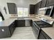 Modern kitchen features stainless steel appliances, stylish countertops, and dark wood cabinets at 8682 Gateway Glen Dr, Las Vegas, NV 89178