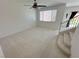 Bright living room with plush carpeting, ceiling fan and natural light at 8682 Gateway Glen Dr, Las Vegas, NV 89178