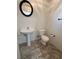 A simple and functional powder room with pedestal sink and tiled floor at 8682 Gateway Glen Dr, Las Vegas, NV 89178