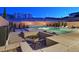 Inviting backyard patio with a modern fire pit, comfortable seating, and lush landscaping, perfect for evening relaxation at 881 Barrhead Ave, Henderson, NV 89012