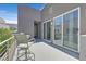 Private balcony with seating area, offering an inviting outdoor space and city views, perfect for relaxation at 881 Barrhead Ave, Henderson, NV 89012