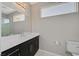 A well-lit bathroom with a large mirror, sleek vanity, and modern fixtures at 881 Barrhead Ave, Henderson, NV 89012