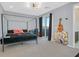 A cozy bedroom featuring a four-poster bed, modern lighting, and sliding doors to a balcony at 881 Barrhead Ave, Henderson, NV 89012