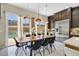 Dining area with a large table, modern chairs, and view of the outdoor pool at 881 Barrhead Ave, Henderson, NV 89012