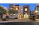 Contemporary two-story home with modern design, stone accents, two-car garage, and desert landscaping at 881 Barrhead Ave, Henderson, NV 89012