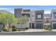 Modern two-story home with gray and white exterior, complemented by landscaped front yard and attached garage at 881 Barrhead Ave, Henderson, NV 89012