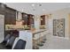 Modern kitchen with a center island, white countertops, stainless steel appliances, and a wine rack at 881 Barrhead Ave, Henderson, NV 89012