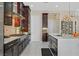 Modern kitchen with stainless steel appliances, white countertops, and dark wood cabinetry at 881 Barrhead Ave, Henderson, NV 89012