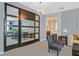 Inviting living area with sleek mirrored sliding doors, stylish seating, and elegant decor, seamlessly connecting to the bathroom at 881 Barrhead Ave, Henderson, NV 89012