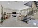 Stylish living room with contemporary decor, a staircase, tile floors, and lots of light at 881 Barrhead Ave, Henderson, NV 89012