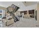 Open-concept living space with stairs, modern kitchen, dining area, and tile flooring at 881 Barrhead Ave, Henderson, NV 89012