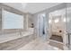 Elegant bathroom with a soaking tub, walk-in shower, and luxurious finishes, creating a serene and inviting space at 881 Barrhead Ave, Henderson, NV 89012