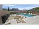 Resort-style pool area with a spa, fire pit, and lounge seating at 881 Barrhead Ave, Henderson, NV 89012