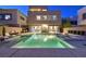Backyard pool with lush landscaping, lounge chairs, outdoor dining, and a relaxing spa at 881 Barrhead Ave, Henderson, NV 89012