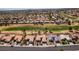 Expansive aerial view showcases a neighborhood with mature landscaping, a golf course, and well-maintained homes at 9425 Villa Ridge Dr, Las Vegas, NV 89134