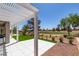 Inviting backyard featuring a covered patio, pristine artificial grass, and picturesque golf course backdrop at 9425 Villa Ridge Dr, Las Vegas, NV 89134