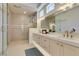 Modern bathroom featuring dual sinks, a glass shower, and stylish gold fixtures at 9425 Villa Ridge Dr, Las Vegas, NV 89134