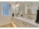 Bathroom with double sinks, modern fixtures, and a glass block window at 9425 Villa Ridge Dr, Las Vegas, NV 89134