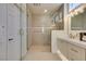 Modern bathroom with a walk-in shower and double vanity, with modern hardware at 9425 Villa Ridge Dr, Las Vegas, NV 89134