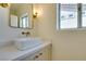 Elegant powder room featuring a vessel sink, modern fixtures, and natural light at 9425 Villa Ridge Dr, Las Vegas, NV 89134