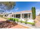 Attractive home exterior with a pergola-covered patio, landscaped yard, and sliding glass doors at 9425 Villa Ridge Dr, Las Vegas, NV 89134