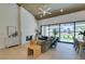 Bright living room featuring a modern fireplace, vaulted ceiling, and sliding glass doors with golf course views at 9425 Villa Ridge Dr, Las Vegas, NV 89134