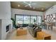 Bright living room featuring a modern fireplace, vaulted ceiling, and sliding glass doors with golf course views at 9425 Villa Ridge Dr, Las Vegas, NV 89134