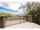 A lovely balcony view overlooking a quiet street with lush trees and community homes, creating a relaxing ambiance at 9545 Parker Springs Ct, Las Vegas, NV 89166
