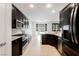 Modern kitchen boasts dark wood cabinets, stainless steel appliances, and granite countertops at 9545 Parker Springs Ct, Las Vegas, NV 89166