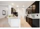 Stylish kitchen featuring granite countertops, stainless steel appliances, and dark wood cabinetry with modern fixtures at 9545 Parker Springs Ct, Las Vegas, NV 89166