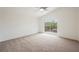 Main bedroom features carpeted flooring and sliding glass door leading to the balcony at 9545 Parker Springs Ct, Las Vegas, NV 89166
