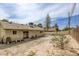 Large backyard with a stone pathway, mature trees, and ample space for outdoor activities and entertaining at 1012 Winwood St, Las Vegas, NV 89108