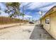 Spacious backyard featuring gravel landscaping, a wood fence, and mature trees in a desirable neighborhood at 1012 Winwood St, Las Vegas, NV 89108