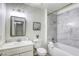 Bright bathroom featuring a marble-tiled shower, white fixtures, and a sleek, modern design at 1012 Winwood St, Las Vegas, NV 89108