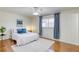 Cozy bedroom with hardwood floors, a plush rug, and ample natural light from the window at 1012 Winwood St, Las Vegas, NV 89108