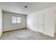 Bright bedroom with neutral carpet, a large window, and a closet for ample storage at 1012 Winwood St, Las Vegas, NV 89108
