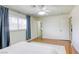 Well-lit bedroom with hardwood floors, blue accents and a convenient ensuite bathroom at 1012 Winwood St, Las Vegas, NV 89108