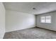 Spacious bedroom with plush carpet, a large window, and neutral tones for a calming atmosphere at 1012 Winwood St, Las Vegas, NV 89108