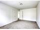 Carpeted bedroom with two closets, a window, and neutral color scheme, perfect for relaxing at 1012 Winwood St, Las Vegas, NV 89108